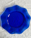 This blue colored glass plate in a flower-like curvy shape is a perfect dinner plate. 