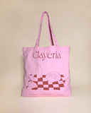 Our high-quality Clayeria Shopper made out of durable and thick cotton gives your outfit the perfect pop of color. The powdery pink bag with our signature tablescape illustration in terracotta comes in the perfect size to carry your laptop to work, your pottery tools to the atelier or simply your essential knick-knacks wherever the day might take you.