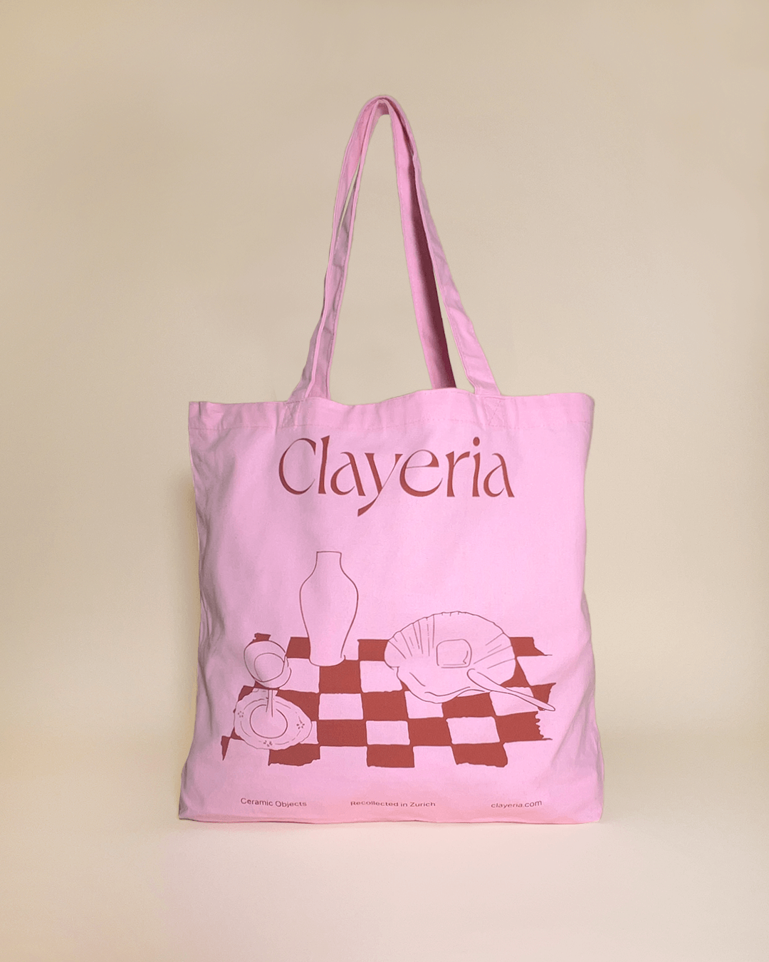 Our high-quality Clayeria Shopper made out of durable and thick cotton gives your outfit the perfect pop of color. The powdery pink bag with our signature tablescape illustration in terracotta comes in the perfect size to carry your laptop to work, your pottery tools to the atelier or simply your essential knick-knacks wherever the day might take you.