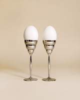 These wavy egg cups are the perfect decorative yet functional element for a cool breakfast or brunch table. The egg cups come in a set of 2.