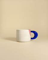 This chunky ceramic mug by Laura Liza has a wheel thrown body and a hand-sculpted handle with contrasting color combinations. The mug is perfect for a cup of coffee, a creamy matcha, a tea or a sweet hot chocolate, whatever you prefer. The ceramic mug fits perfectly with the dotted ceramic plate and highlights a fine breakfast table.
